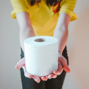 image of woman holding toilet paper